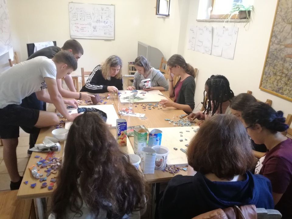 Volunteers creating a mosaic together in Kryoneri, Greece